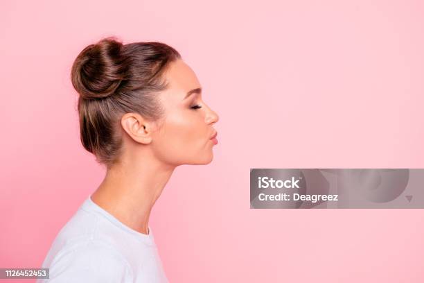 Profile Side View Portrait Of Her She Nice Cute Attractive Lovely Sweet Cheerful Girl Lady Kissing You Isolated Over Pastel Pink Background Stock Photo - Download Image Now