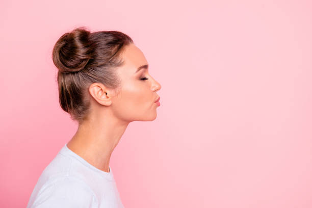 profile side view portrait of her she nice cute attractive lovely sweet cheerful girl lady kissing you isolated over pastel pink background - beijar imagens e fotografias de stock