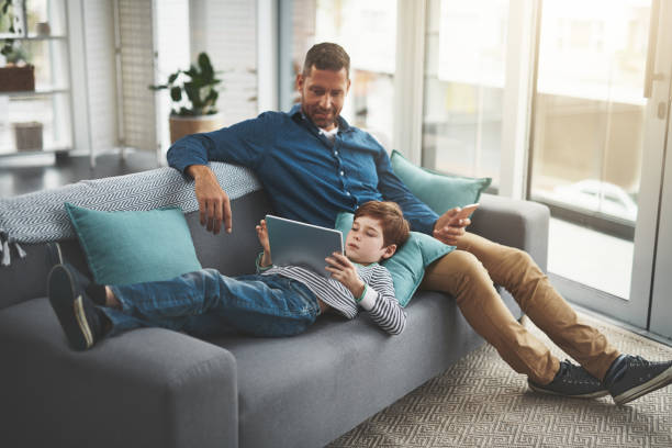 istock What are you reading there son? 1126452604
