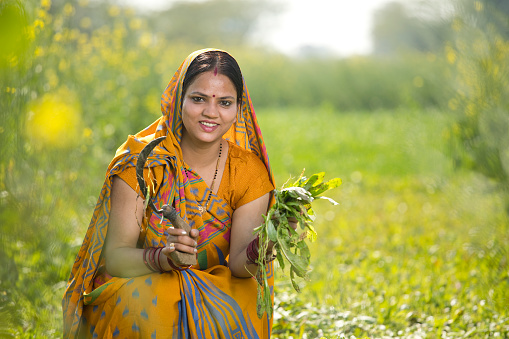 Woman farmer in rapeseed agricultural field