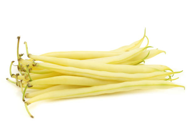 Bunch of yellow wax beans on a white background