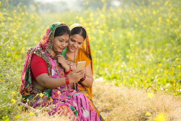 istock Rural women using mobile phone in agricultural field 1126454593