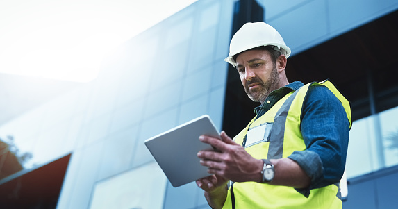 Shot of a engineer using a digital tablet on a construction site