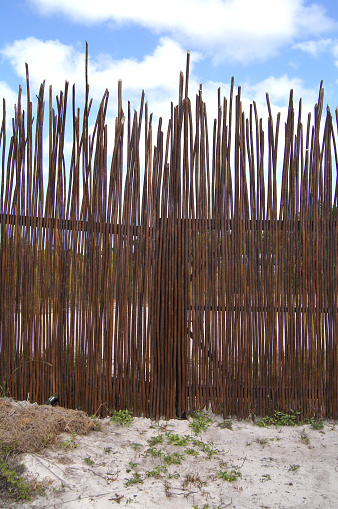Bamboo Wall, Fence or Gate on Beach with Blue Sky. Shot with a SONY DSC.