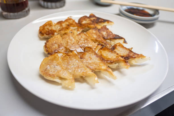 istock Japanese dumpling or Gyoza on the white plate with soy sauce 1126460373
