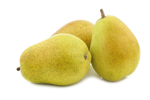 three fresh Lucas pears on a white background