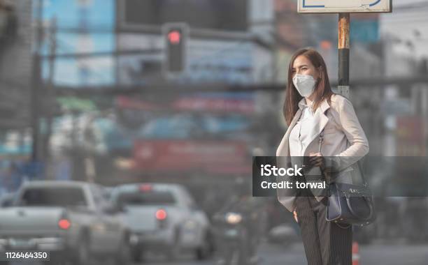 Asian Woman Are Going To Workshe Wears N95 Maskprevent Pm25 Dust Stock Photo - Download Image Now