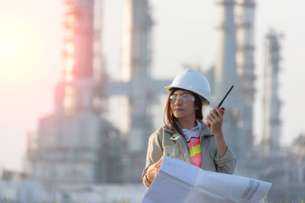 engineers woman holding radio, blueprint and report schedule for workers security control at power plant energy industry, engineer concept,professional,safety,industry - social housing audio imagens e fotografias de stock