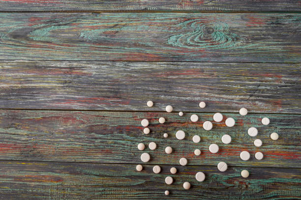 istock White pill on a wooden background with copy space. 1126465264