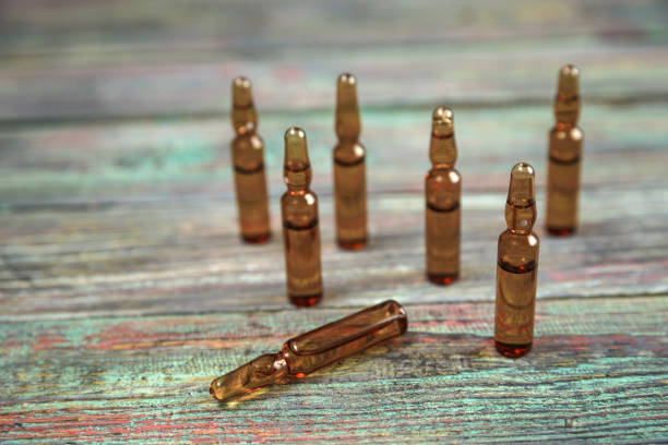 istock Injection bottle on wooden background with copy space 1126466831