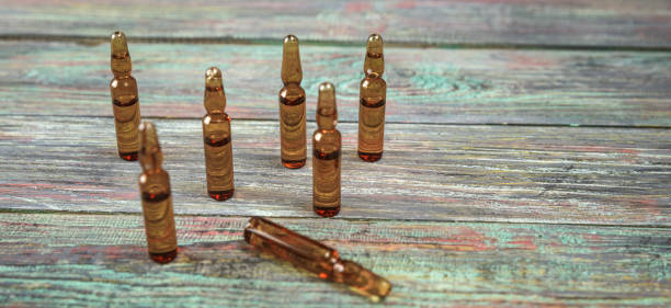istock Injection bottle on wooden background with copy space 1126466836