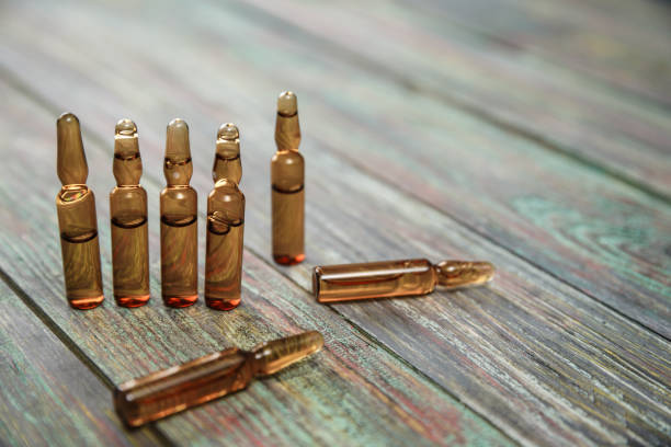 istock Injection bottle on wooden background with copy space 1126466913
