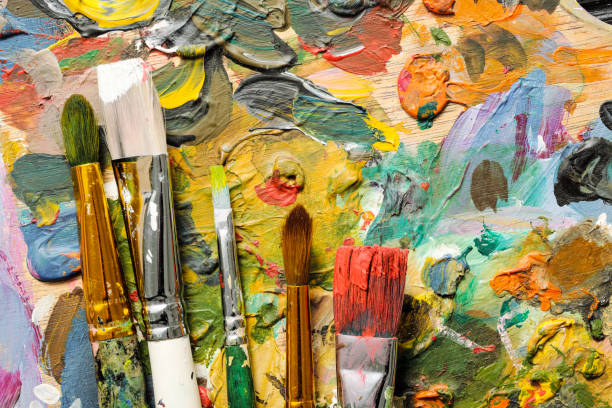 The tools of the artist, brushes, paints and palette not dark wooden background. stock photo