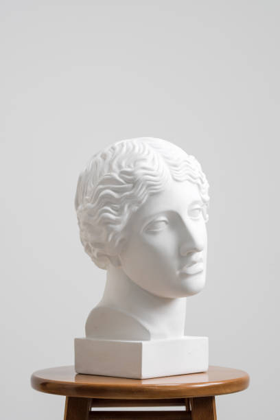 istock Plaster head, antique sculpture for learning to draw. Standing on a stool on a white background. 1126467698