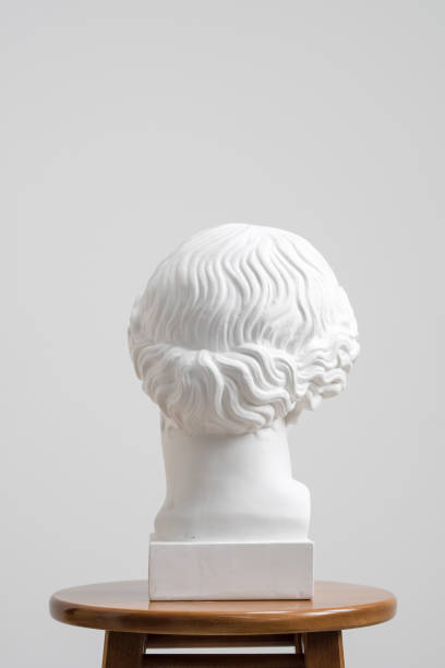 istock Plaster head, antique sculpture for learning to draw. Standing on a stool on a white background. 1126468212