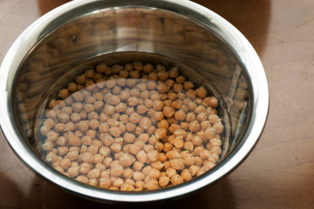 istock Chickpeas soaking in a water bowl - cooking hummus 1126468919