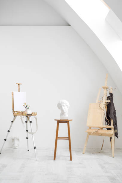 istock White and bright studio with a window. Workspace of the artist. Easel, canvases and plaster figures for learning to draw. 1126468986