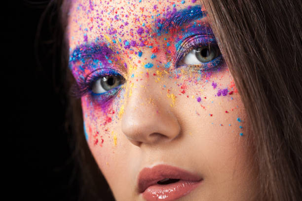 istock explosion of color, multi-colored shadows scattered on the eyelids. Colored Smokey eyes and blue eyebrows. 1126469031