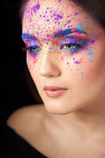 istock Attractive brunette with bright art make-up. Colored Smokey eyes and blue eyebrows. 1126469032