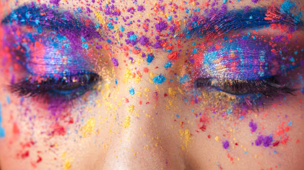 istock explosion of color, multi-colored shadows scattered on the eyelids. Colored Smokey eyes and blue eyebrows. 1126469033