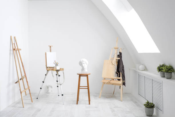 istock White and bright studio with a window. Workspace of the artist. Easel, canvases and plaster figures for learning to draw. 1126469267