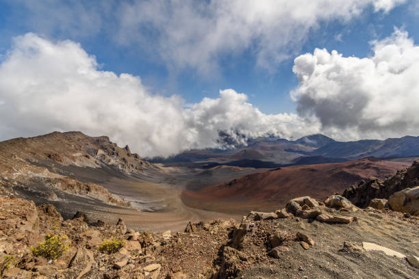 istock A volcanic crater with desert-like scenery, with blue sky and clouds. 1126469732
