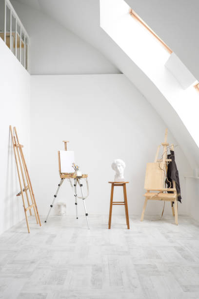 istock White and bright studio with a window. Workspace of the artist. Easel, canvases and plaster figures for learning to draw. 1126470000