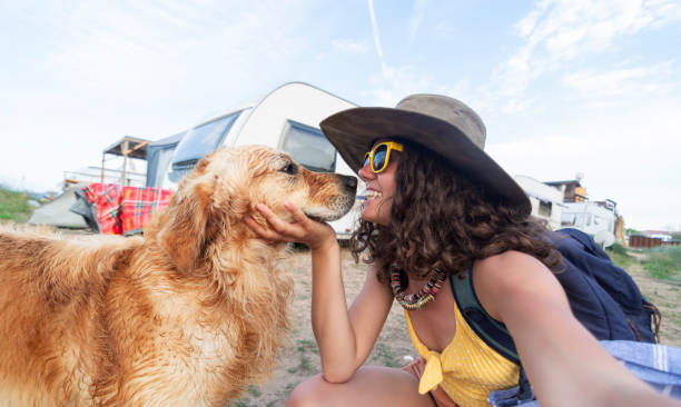 istock Woman With Dog in the beach 1126470658