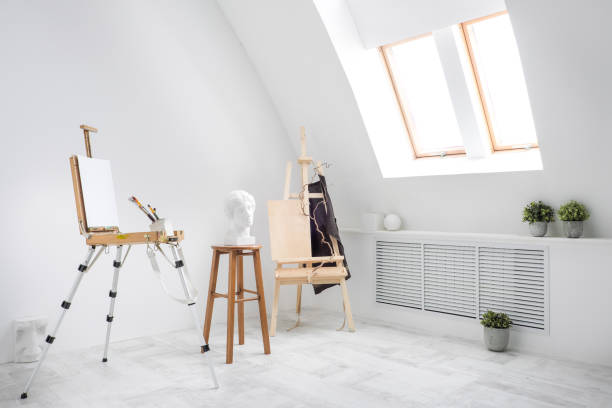 istock White and bright studio with a window. Workspace of the artist. Easel, canvases and plaster figures for learning to draw. 1126470724