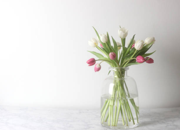 istock Marble with vase of tulips 1126472030