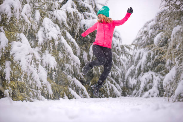 istock Cheerful woman enjoying a snowy winter 1126473238