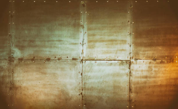 Steampunk style background Metallic block tile wall with rivets. Industrial abstract background. copper wall stock pictures, royalty-free photos & images
