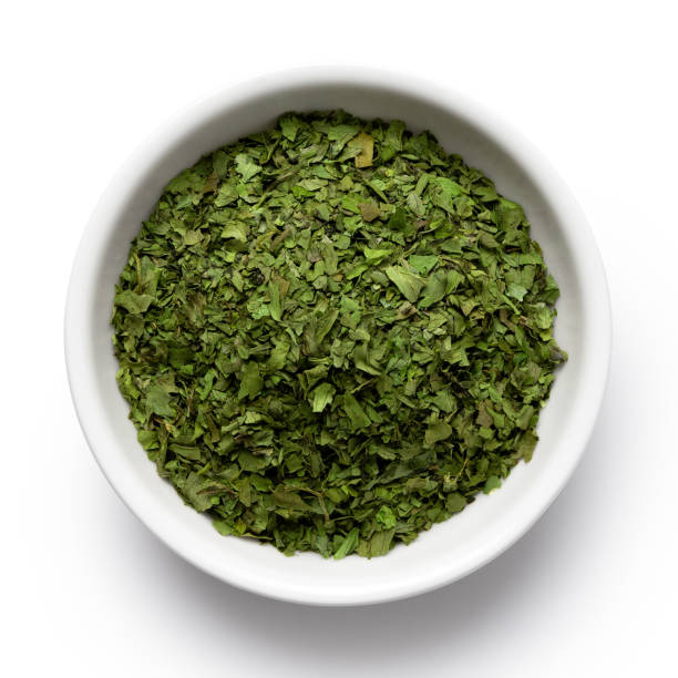 istock Dried chopped coriander leaves in white ceramic bowl isolated on white from above. 1126475098