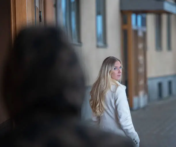 Worried young woman being followed