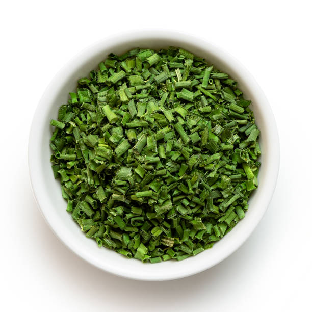 istock Dried chopped chives in white ceramic bowl isolated on white from above. 1126475723
