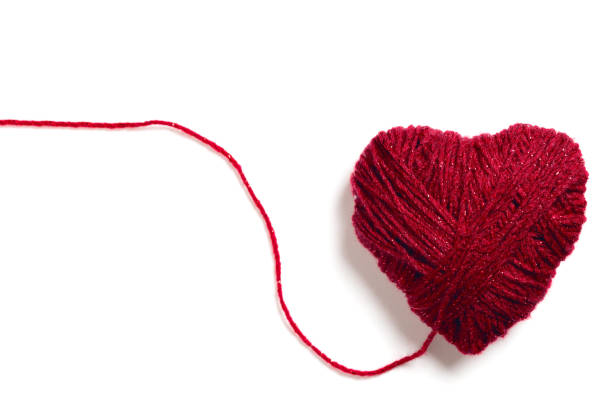 istock Handmade knitted red heart with copy space isolated on white background. Cut out 1126476016