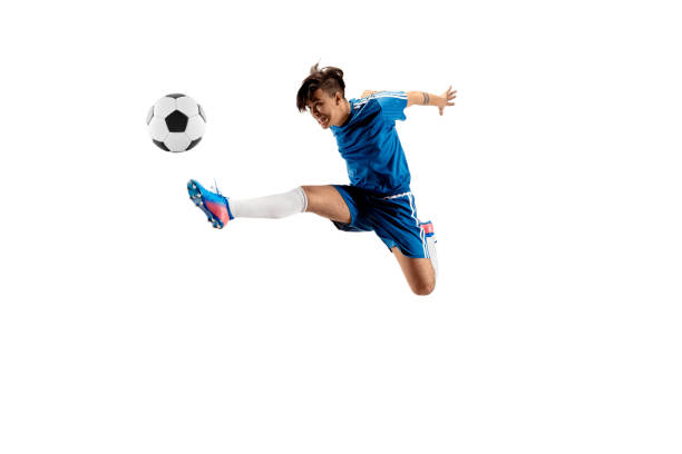 istock Young boy with soccer ball doing flying kick 1126476034