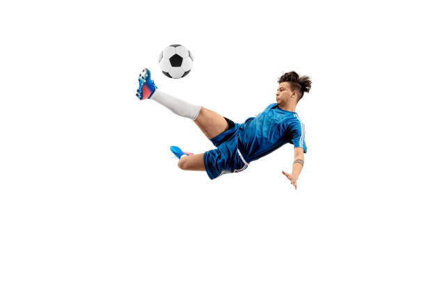 istock Young boy with soccer ball doing flying kick 1126476040