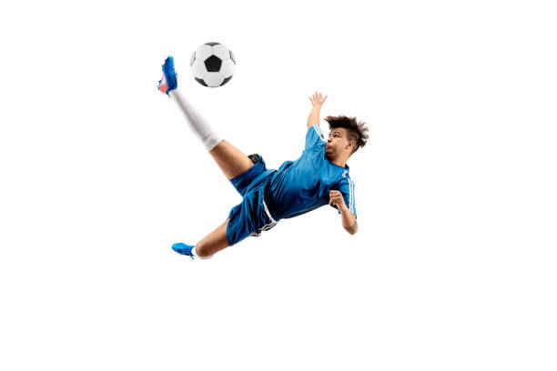 istock Young boy with soccer ball doing flying kick 1126476051