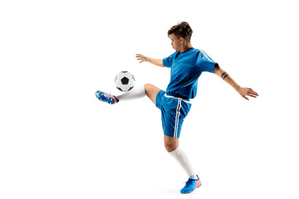 istock Young boy with soccer ball doing flying kick 1126476089