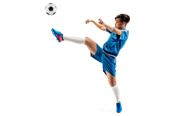 istock Young boy with soccer ball doing flying kick 1126476111