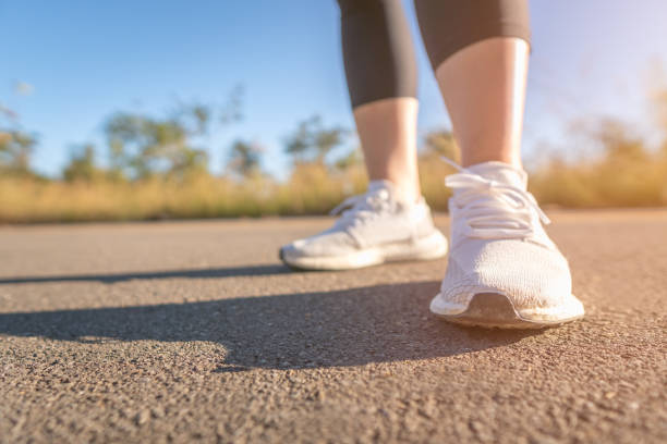 istock Low Section Of Woman Running On Road 1126477289