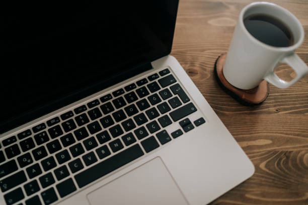 istock Laptop on wooden table with coffee morning and background 1126477765