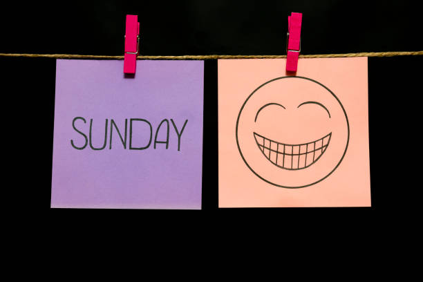 istock Copy space. Two multicolored stickers. On left a sheet inscription sunday. On the right white page an expression of festive mood. 1126477881