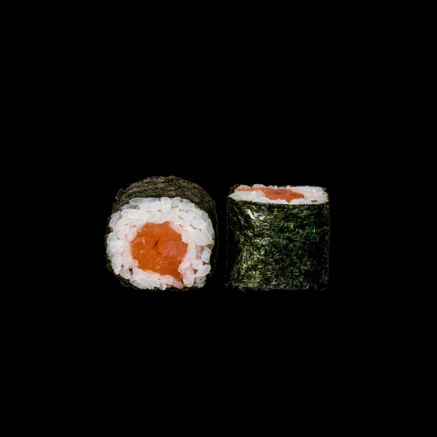 istock Sushi. Roll with tuna in nori leaf, isolated in black background 1126481922