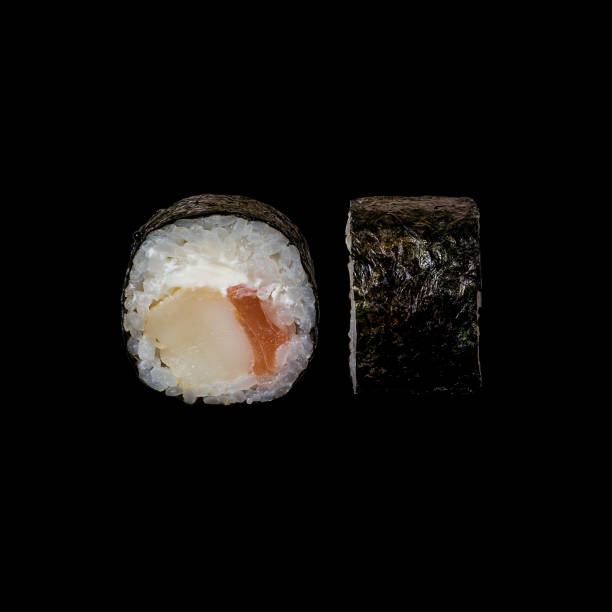 istock Sushi. Roll with shrimp, salmon and cream cheese, isolated in black background 1126481943