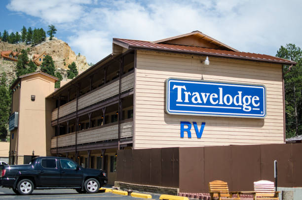 Exterior of a Travelodge motel building in the summer, offering lodging for travelers Keystone, SD - June 20, 2018: Exterior of a Travelodge motel building in the summer, offering lodging for travelers keystone south dakota photos stock pictures, royalty-free photos & images