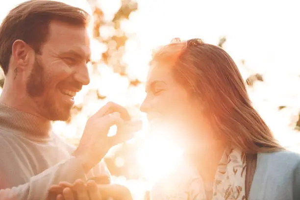 Photo of Couple sharing macaroons