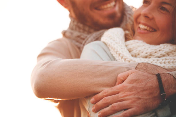 istock Man embracing a woman outdoors 1126484030