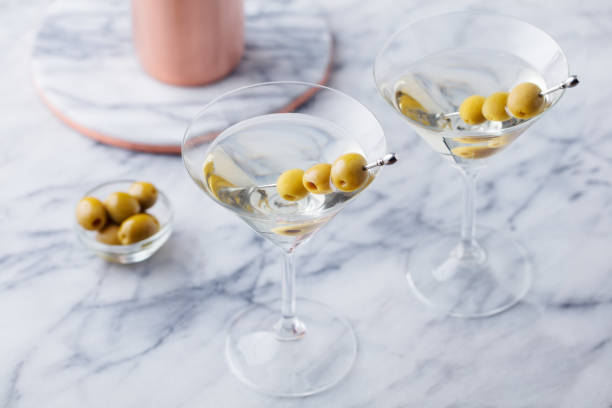 istock Martini cocktail with olives and bar shaker on marble table background. Copy space. 1126484962